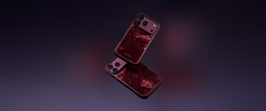 Two Materik PureCase for iPhone 18 Pro in Ruby Reef, floating on a deep purple background