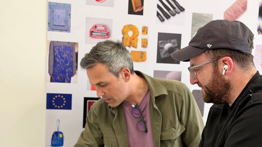 Materik designers reviewing material swatches and texture samples on a studio workbench