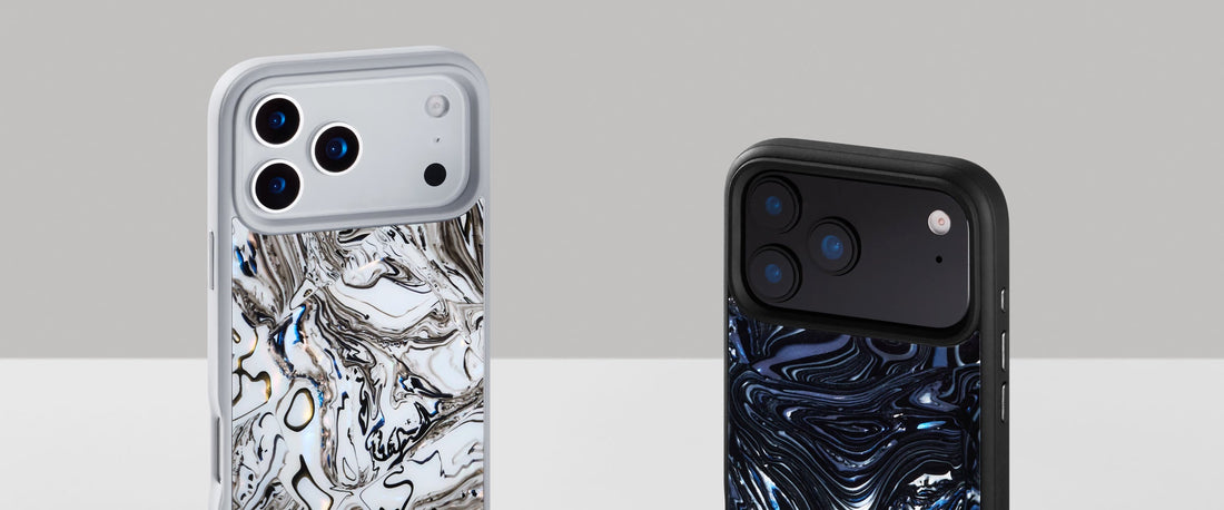 Two Materik iPhone cases in different Mdecor marble patterns, silver and blue, on a soft gradient background