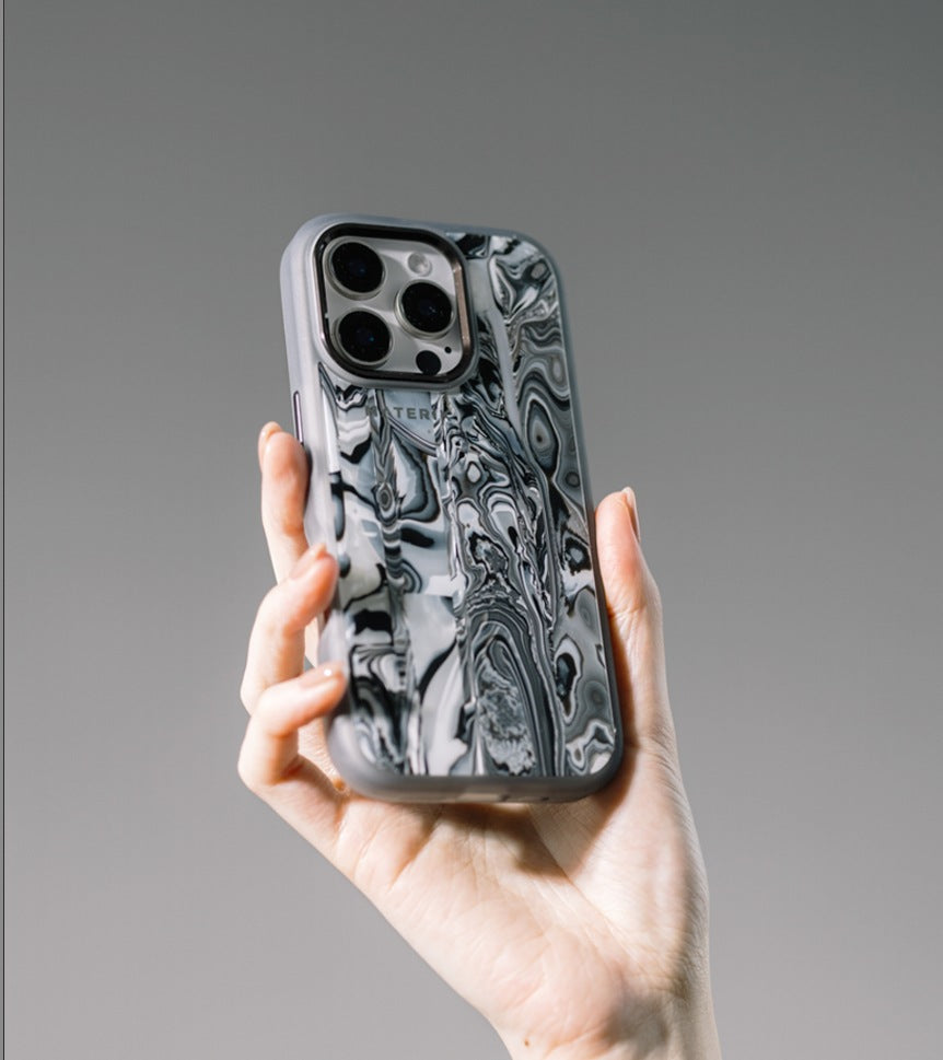 Materik PureCase for iPhone 16 Pro in Black Pearl, handheld lifestyle shot of the Italian pattern